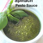 A white bowl filled with fresh spinach pesto sauce