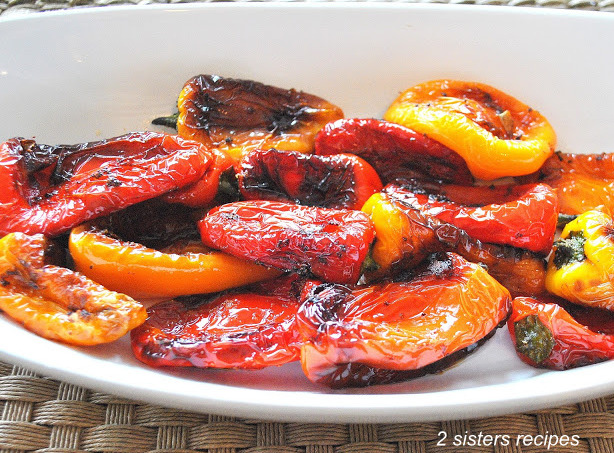 An oval platter with sautéed mini colorful peppers.