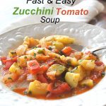 A spoonful of chopped zucchini and tomatoes soup.
