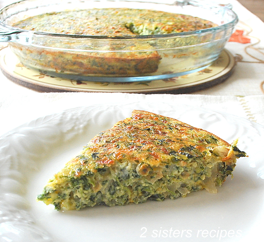 A slice of a crustless Spinach and Cheese Quiche served on a white plate. 