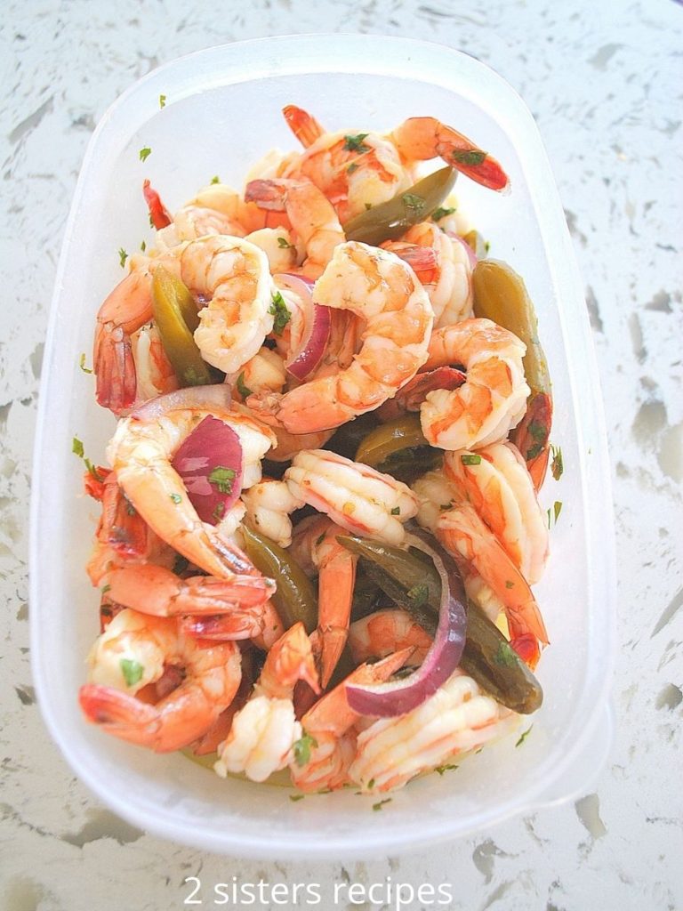 shrimp cocktail in a plastic container to marinate. by 2sistersrecipes.com 