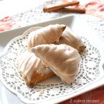 Here are 3 mini scones topped with a glaze, on a white lace paper liner.