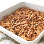 A white baking pan baked with Apple Crisp on top.