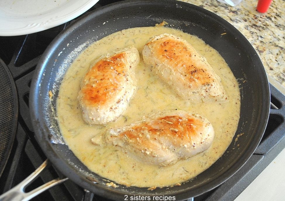 Full photo of chicken sitting in the mustard cream sauce. by 2sistersrecipes.com