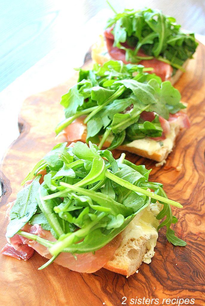 3 smaller pieces of pizza on a wood board. by 2sistersrecipes.com