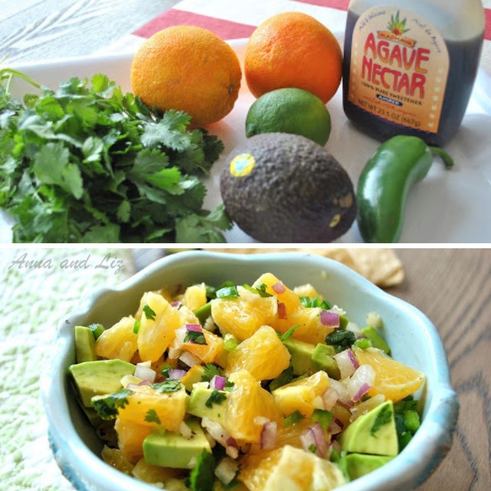 The  ingredients are placed on the table, and a blue bowl filled with chopped orange and avocado. 