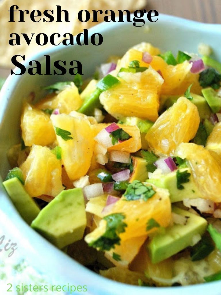 A blue bowl with chopped fresh oranges and avocado.