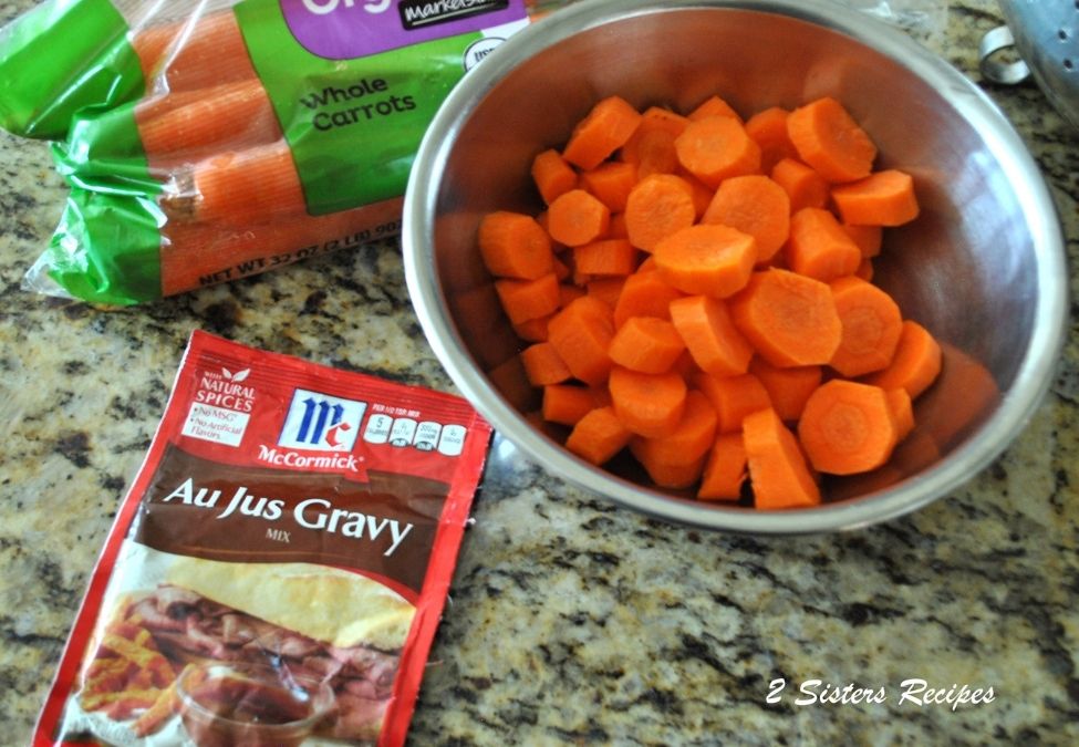 A silver bowl with chopped carrots. by 2sistersrecipes.com