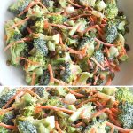 A white salad bowl filled with fresh raw vegetables, broccoli florets, shredded carrots and raisins.