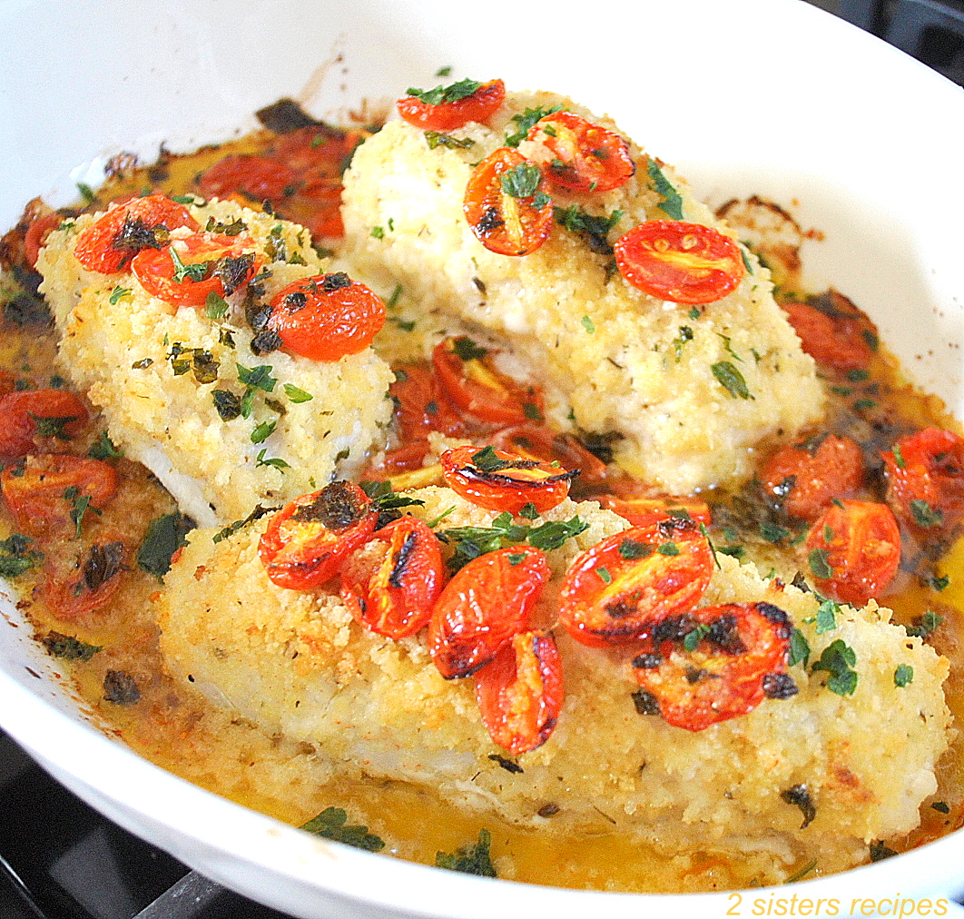 Baked fish with cherry tomatoes on top.