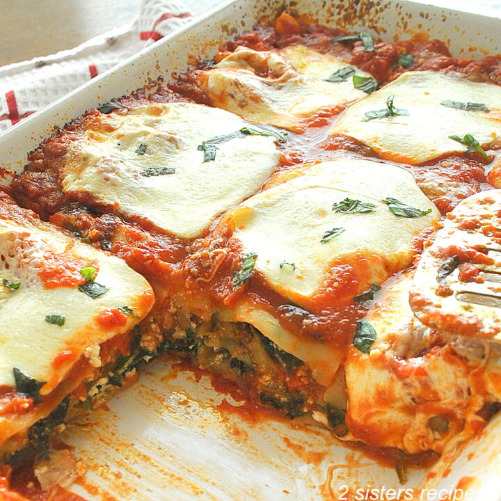 A lasagna filled with spinach and eggplant and topped with melted mozzarella.