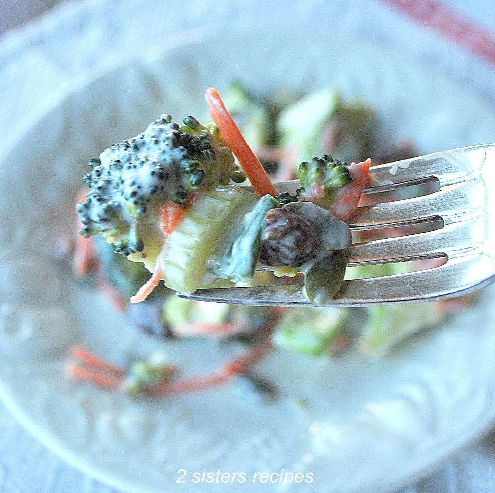 A forkful of broccoli on a fork. by 2sistersecipes.com