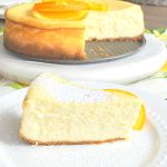 a slice of cheesecake on a white plate. by 2sistersrecipes.com