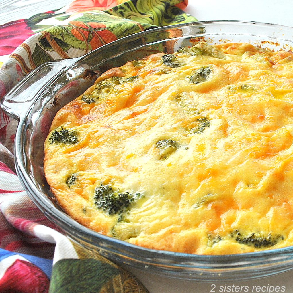 A glass pie dish filled with an egg and broccoli quiche.