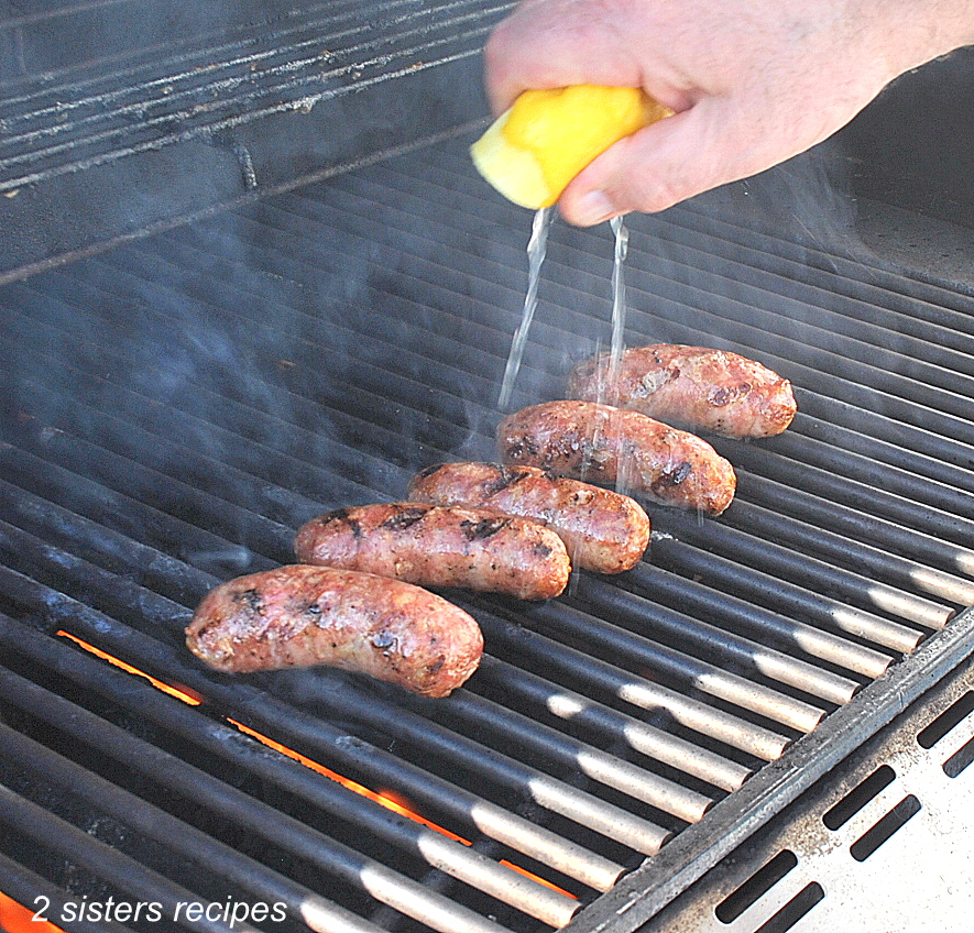 Lemon juiced squeezed over the sausages on the grill.  by 2sistersrecipes.com