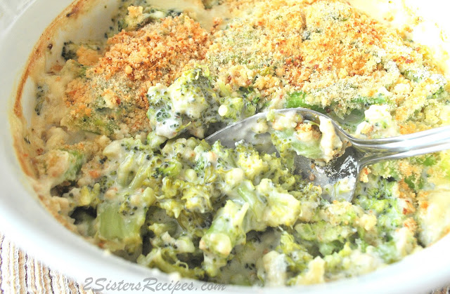 A white casserole dish with broccoli . by 2sistersrecipes.com