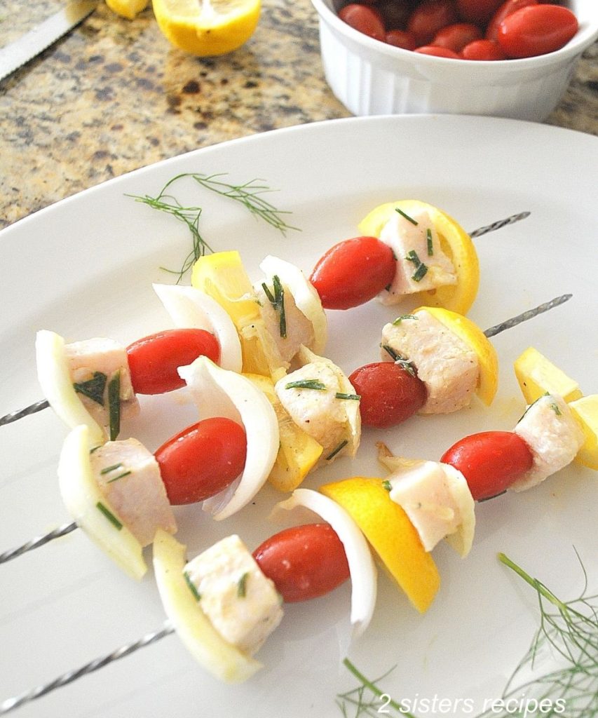 3 Skewers make and on a white platter. by 2sistersrecipes.com