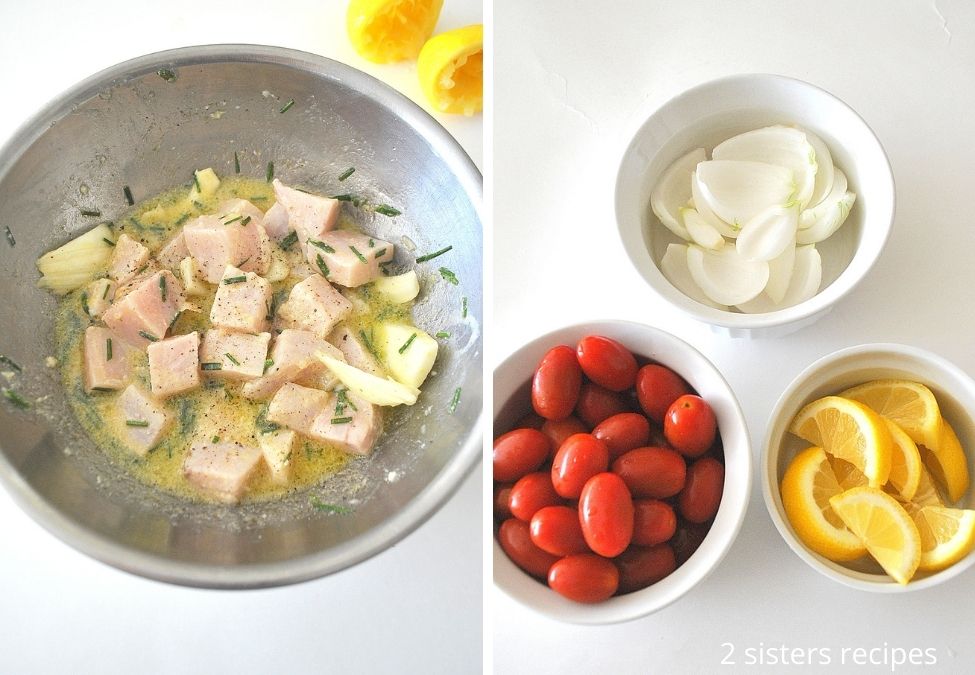 Marinating cubes of swordfish in a silver bowl, and veggies prepped in white small bowls.  by 2sistersrecipes.com 
