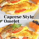 Two omelets stuffed with sliced tomato and melted mozzarella served on a white plate with fresh fruit on the side.