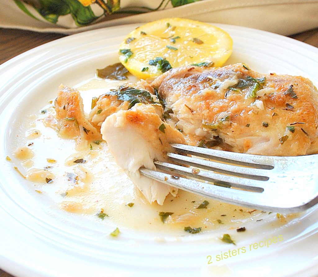 A forkful of white fish on a white plate. by 2sistersrecipes.com