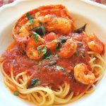 Shrimp and Lobster Sauce served over spaghetti in a white dish.