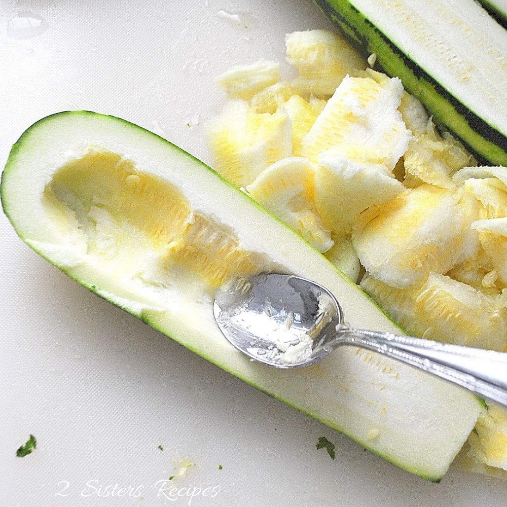 Zucchini sliced in half and hollowed out with a spoon. 