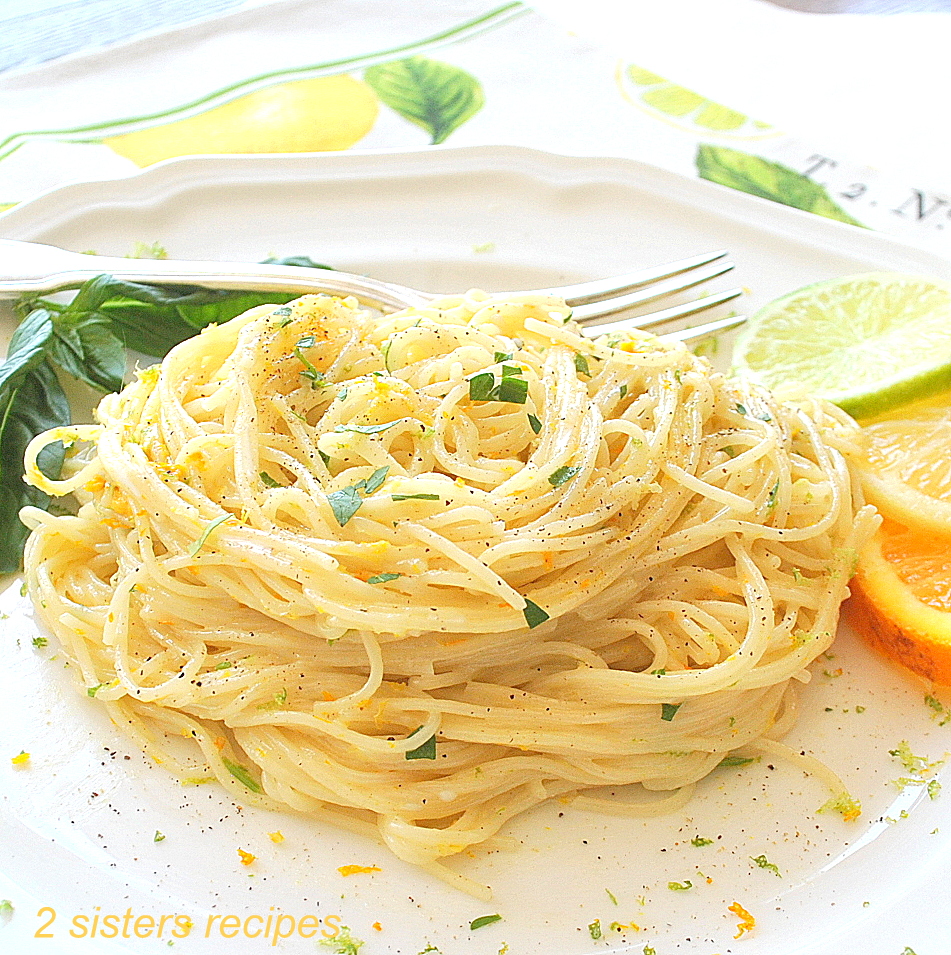 A white plate with angel hair pasta. by 2sistersrecipes.com