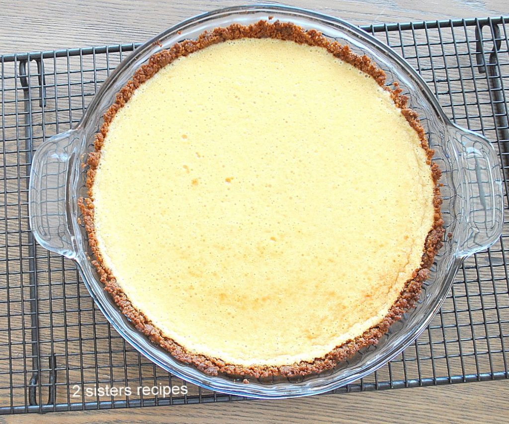 Lemon cream pie cooling on a wire rack. 