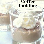 A glass filled with pudding topped with whipped cream.
