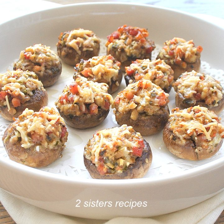 A white round dish filled with stuffed mushroom caps.