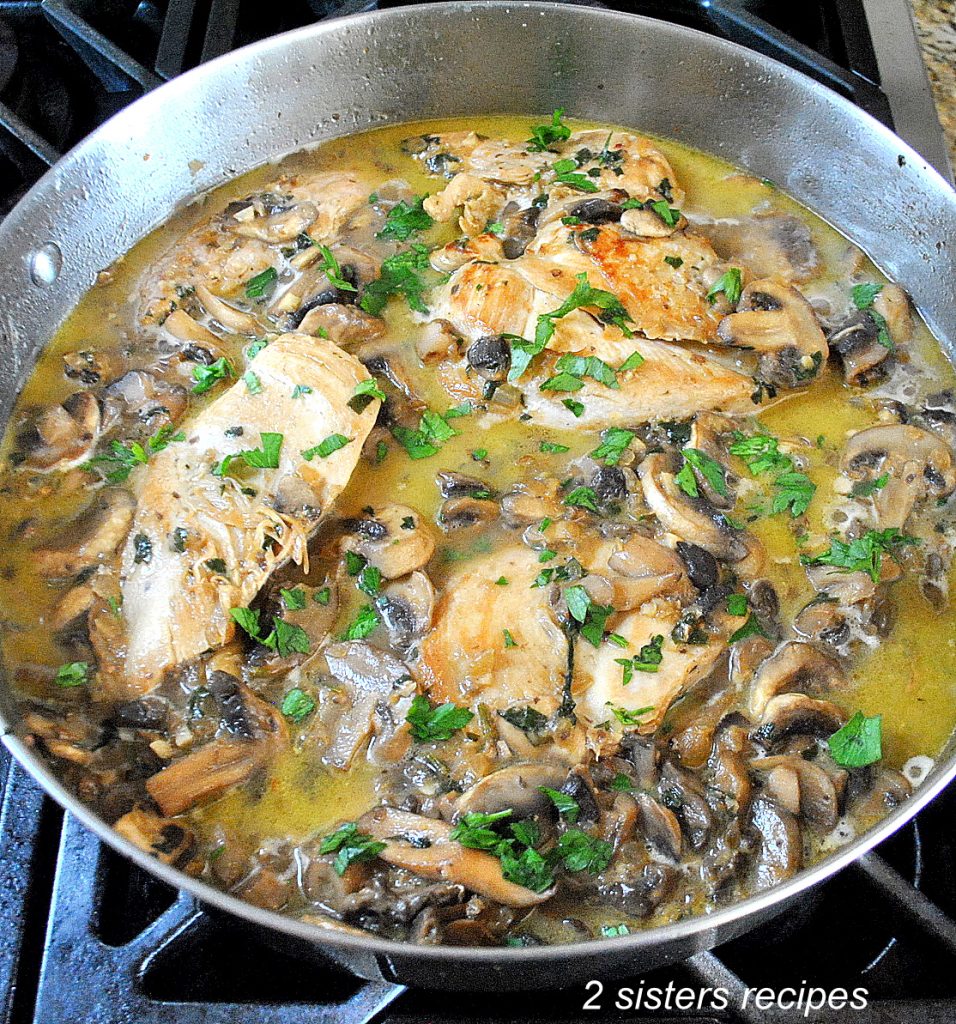 A skillet with chicken and mushrooms sauce. by 2sistersrecipes.com