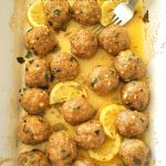A white baking dish filled with Turkey Meatballs with Lemon Sauce.