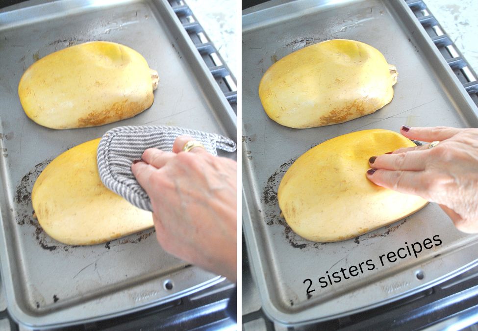 The squash is cut in half and face down on a silver baking sheet. by 2sistersrecipes.com
