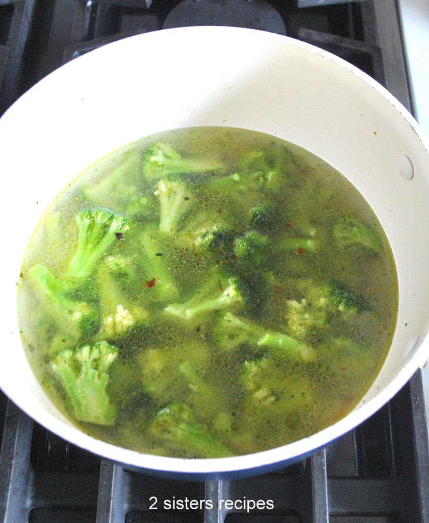 Water is poured into the pot wit broccoli.  by 2sistersrecipes.com