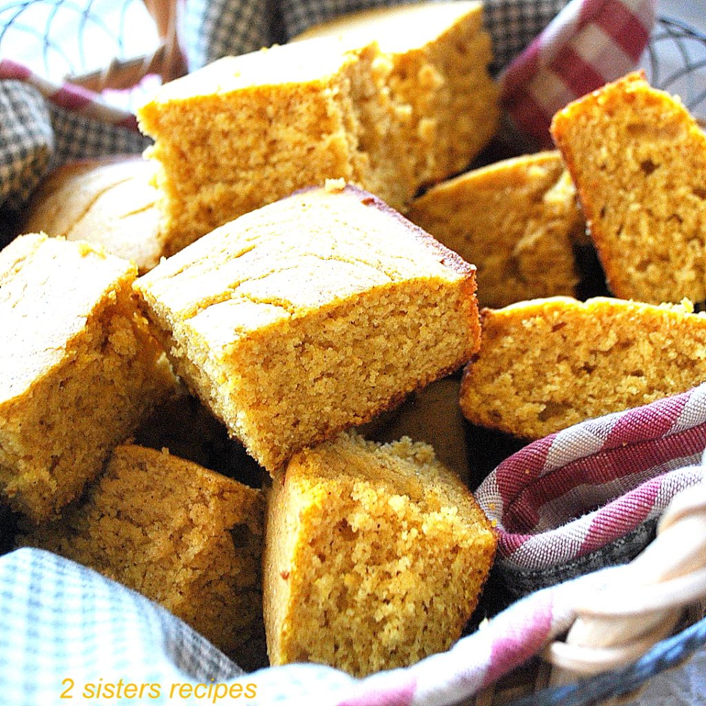 A basket filled with pumpkin cornbread. by 2sistersrecipes.com