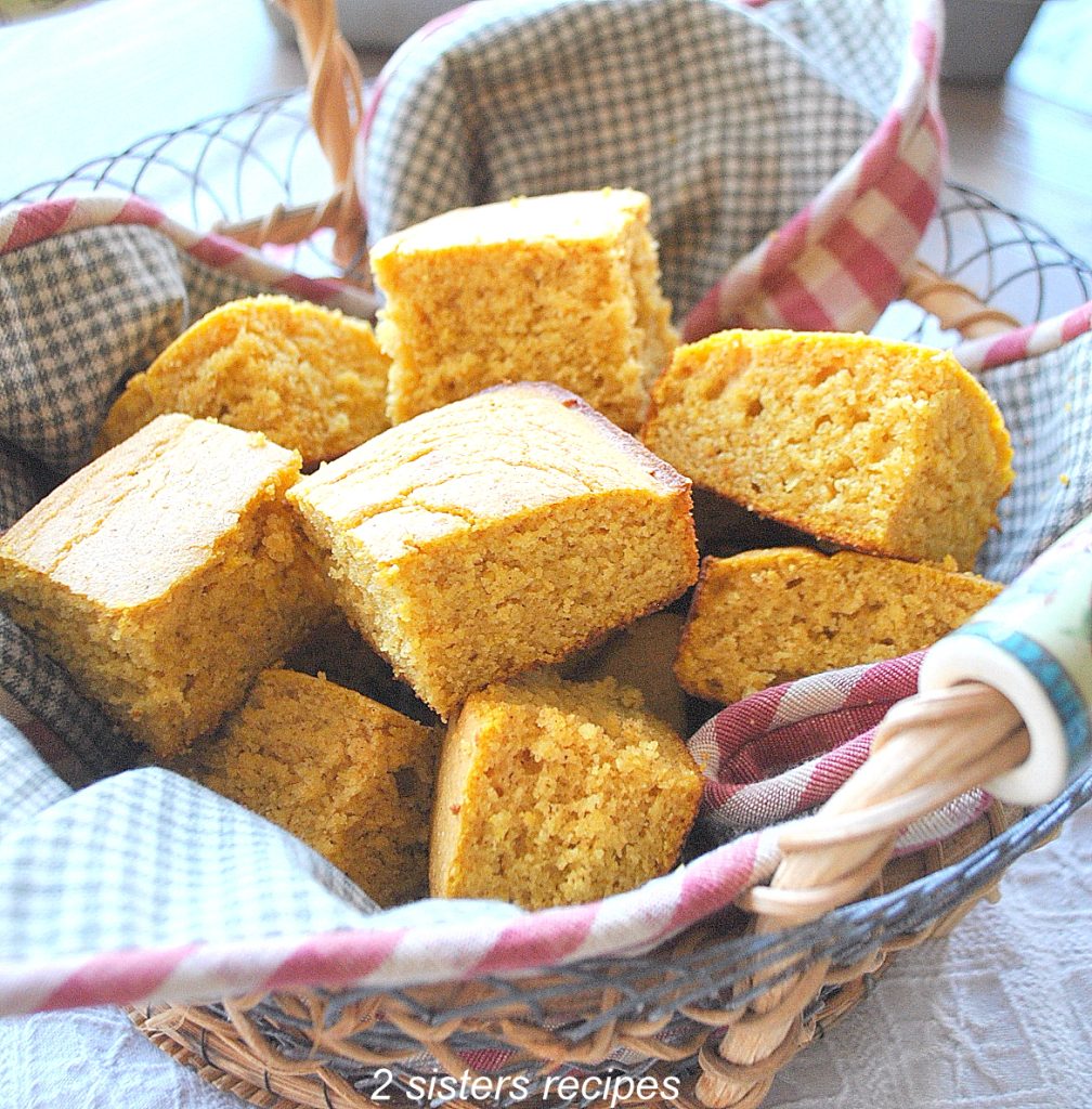 A basket filled with pumpkin cornbread.
