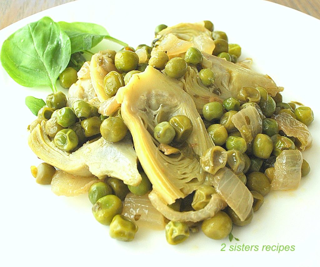 A plate with peas and artichokes hearts. by 2sistersrecipes.com