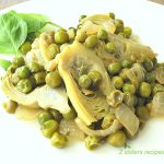A white plate with a serving of peas and artichokes hearts.