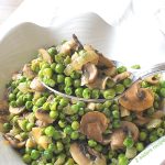 A spoonful of peas and mushrooms.