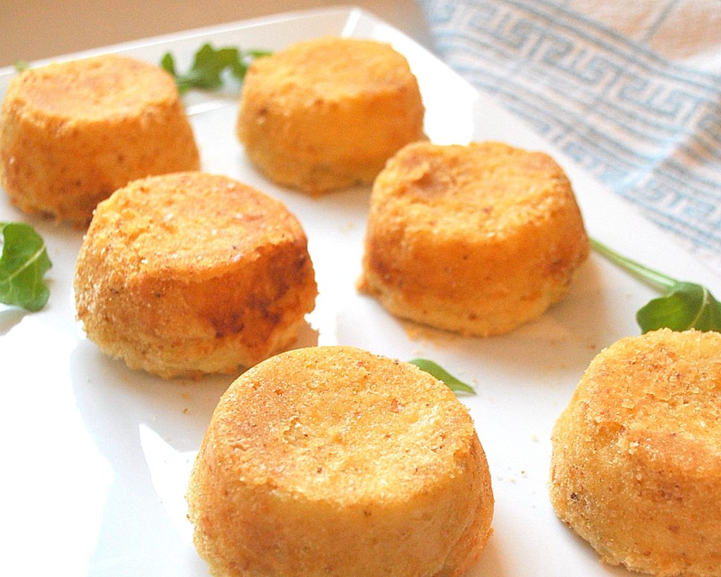 Mashed Potato Cakes ( croquettes) served on a white platter.