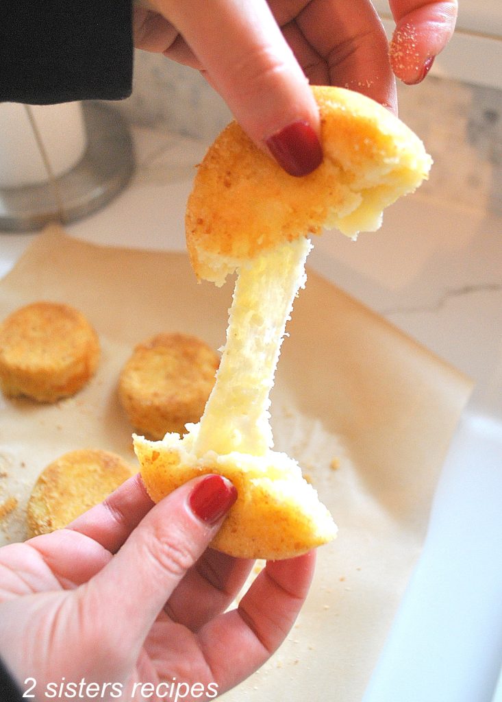 A photo of melted cheese when a potato cake is pulled apart. by 2sistersrecipes.com
