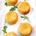 Mashed Potato Cakes baked and served on a white platter.