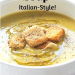 A white bowl of split pea soup with croutons on top.