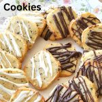 A colorful plate filled with shortbread cookies drizzled with chocolate and white chocolate on top.