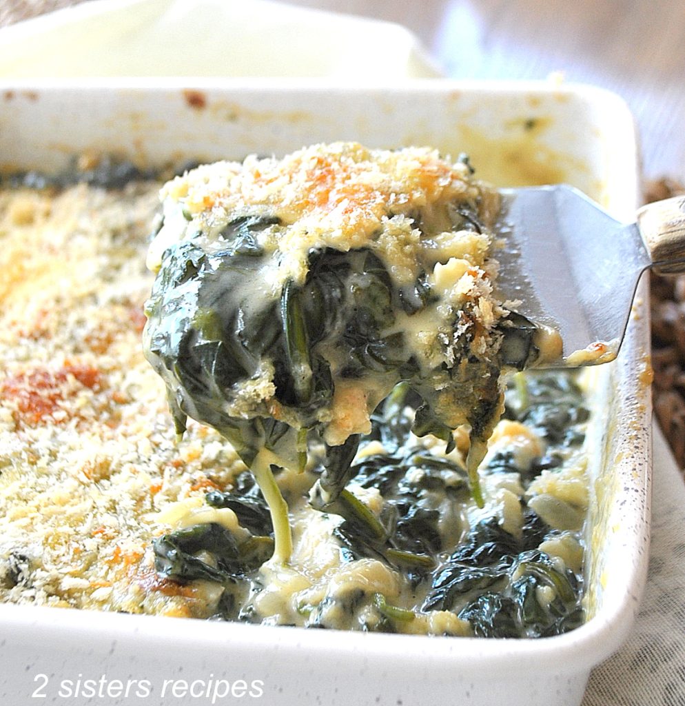 A baking dish with creamy spinach casserole