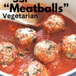 A blue and white skillet with eggplant meatballs and tomato sauce.