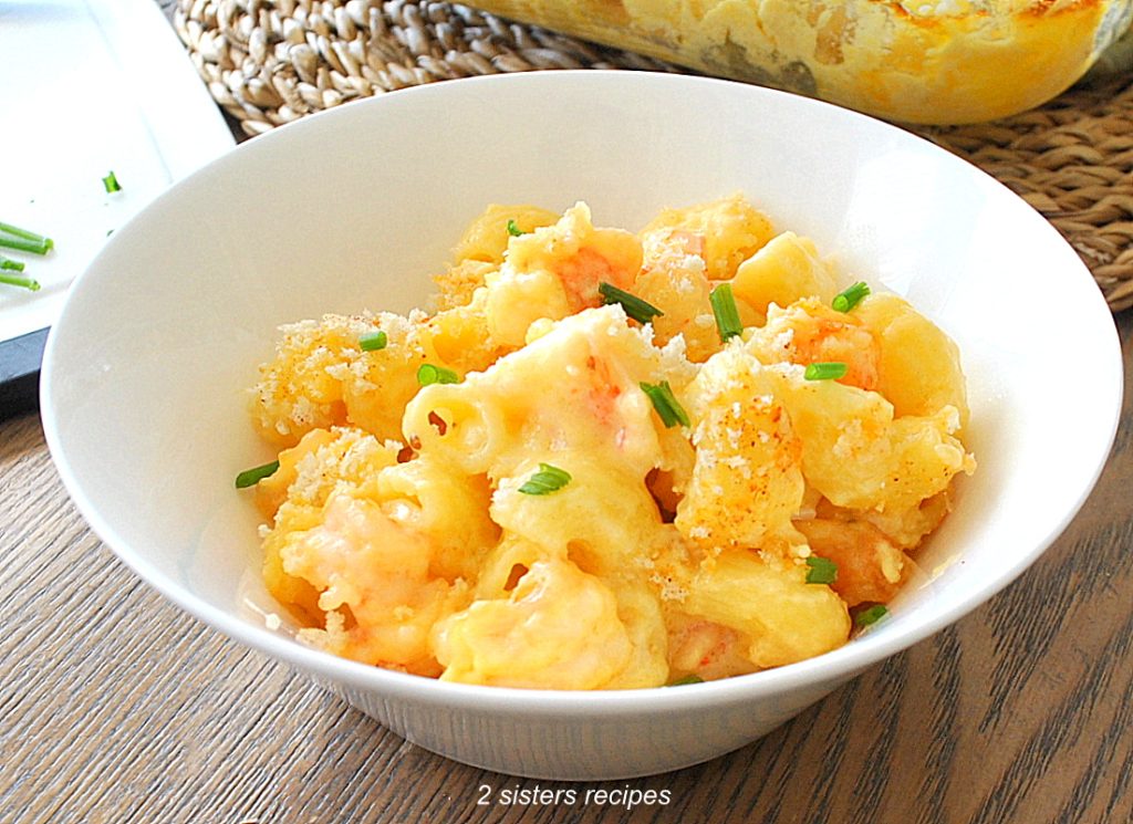 A white bowl filled with shrimp mac and cheese.