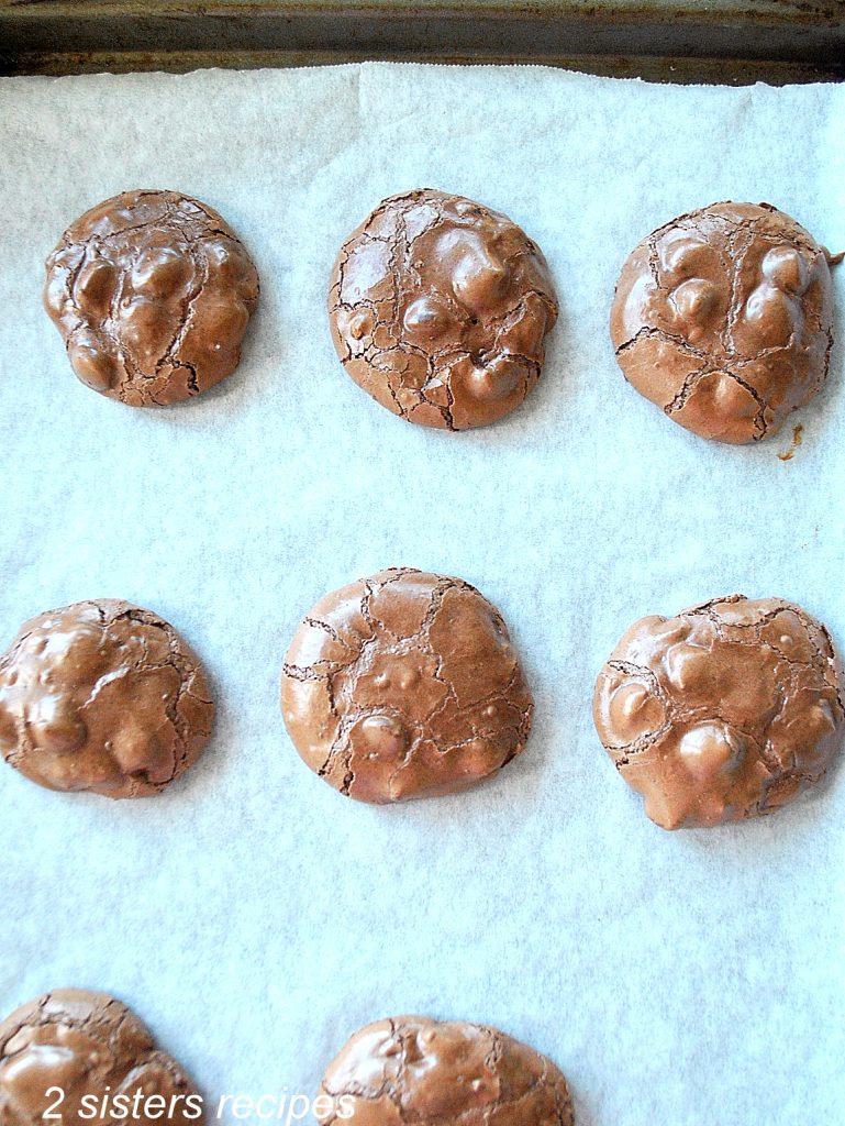 A cookie sheet with baked chocolate fudge cookies. by 2sistersrecipes.com