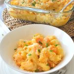 A white bowl filled with shrimp mac and cheese.