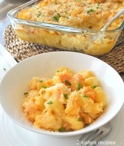 A white bowl filled with shrimp mac and cheese.